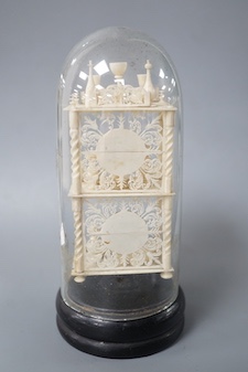 A Victorian ivory model of objects on a whatnot, under a glass dome 16cm